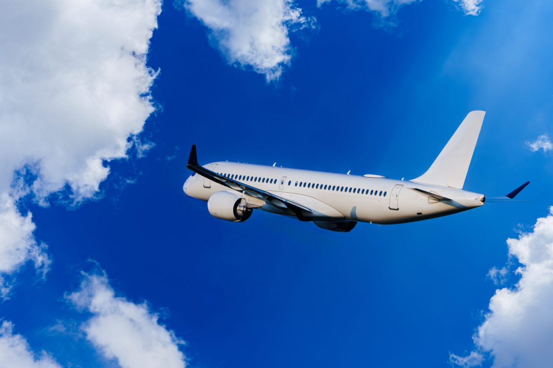 Passengers Commercial airplane flying above dramatic clouds. Concept of fast travel, holidays and business. Commercial transportation concept